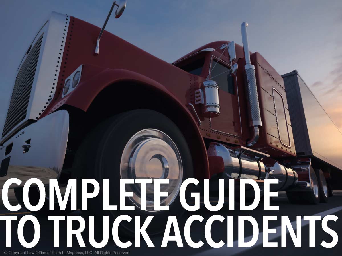 close-up shot of an 18-wheeler truck from below with text white text over the image that says "Complete Guide to Truck Accidents"